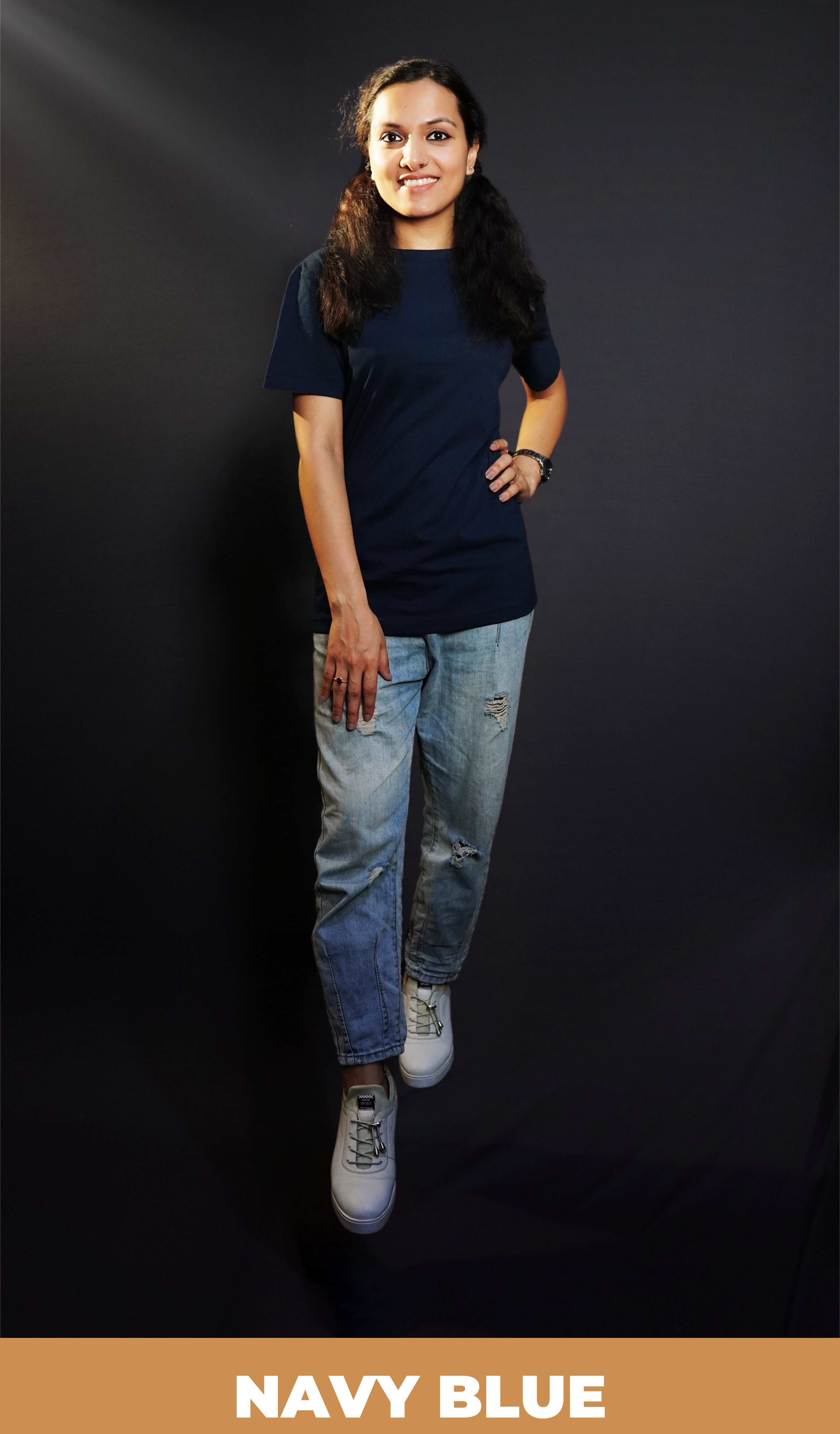 A stylish model wearing a unisex plain round neck navy blue t-shirt, posing with her hand on her waist and other on her thigh, showcasing a trendy snug fit-Muselot