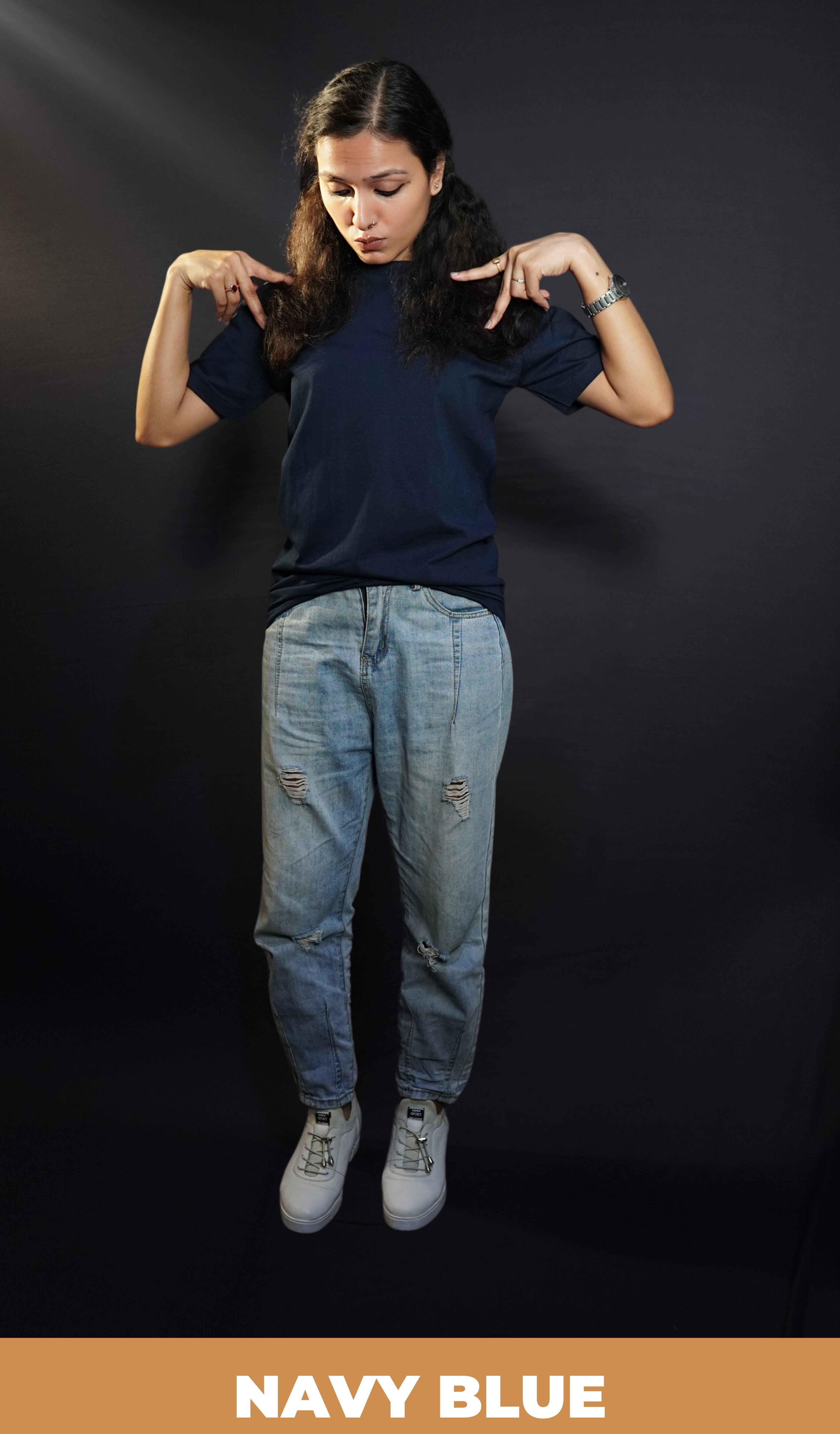 A woman wearing a round neck quick drying short sleeved navy blue t-shirt, posing with her hands making a v on her shoulder, showcasing a cool cozy fit-Muselot