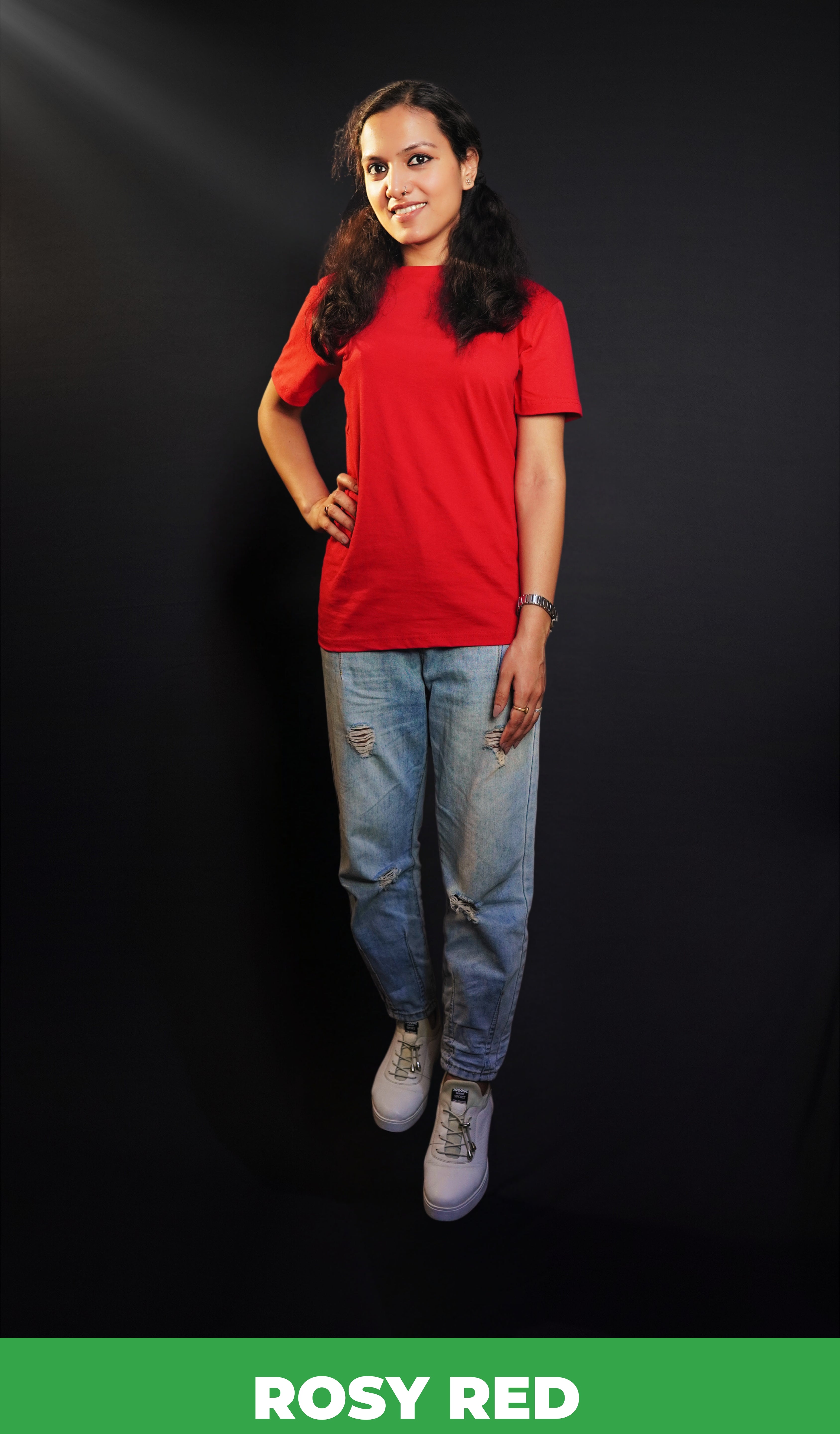A stylish model standing straight as her hand hangs on her side and another on her waist, wearing a unisex plain rosy red round neck t-shirt. showcasing a fashionable in vogue look-Muselot