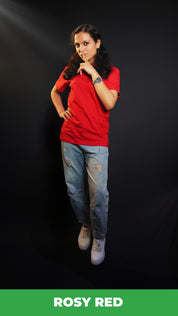 A woman posing with her finger on her lips and a hand on her waist, wearing a plus size round neck stretchable rosy red t-shirt, showcasing a popular easygoing fit-Muselot