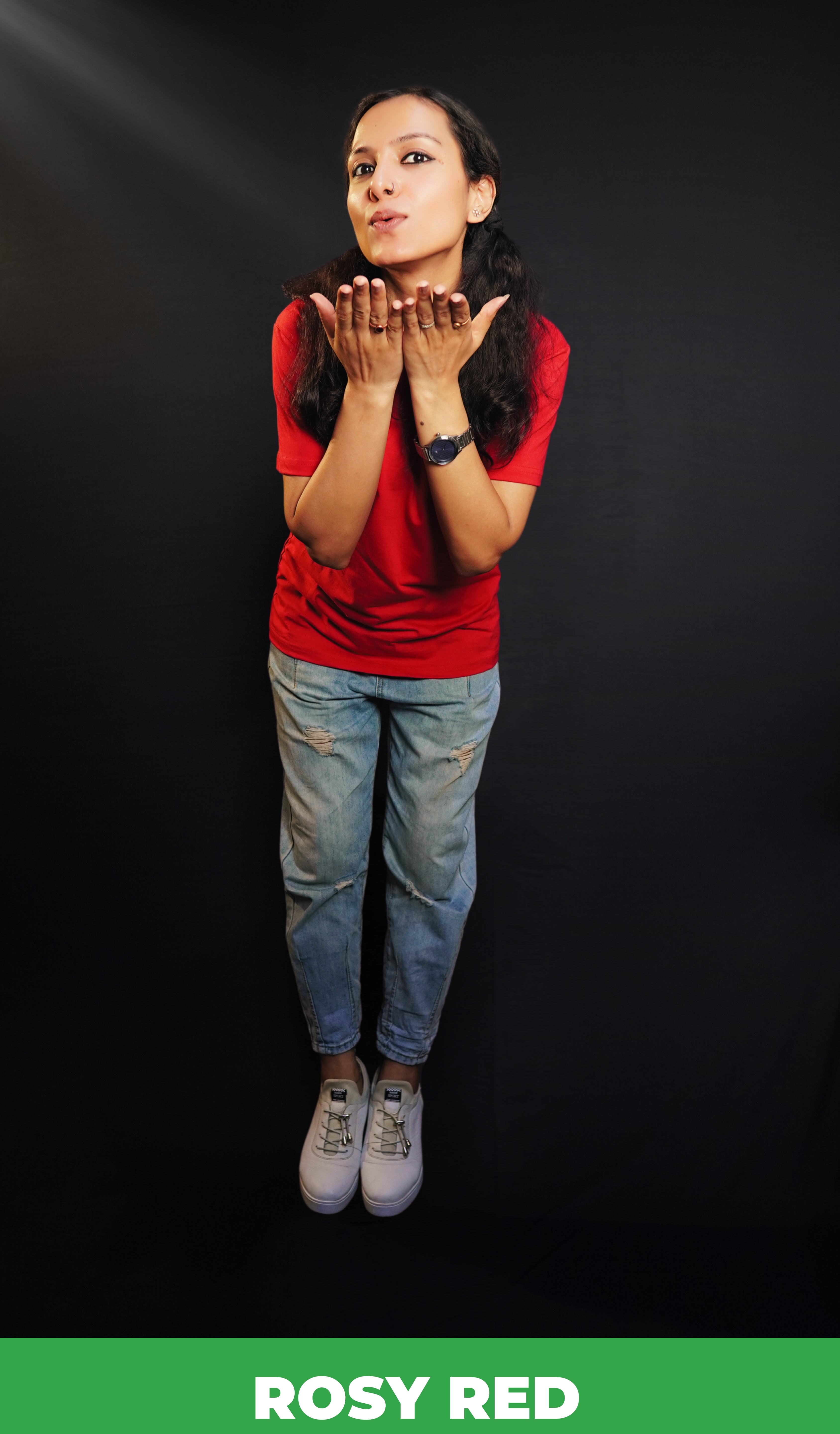 A woman wearing a plus size plain cotton stretchable t-shirt, posing as she offer a flying kiss with her palms stretched near her chin, showcasing a trendy baggy fit-Muselot