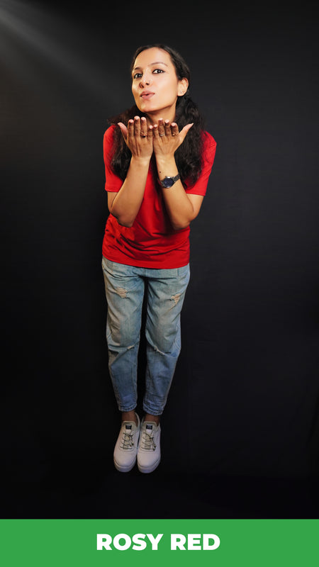 A woman wearing a plus size plain cotton stretchable t-shirt, posing as she offer a flying kiss with her palms stretched near her chin, showcasing a trendy baggy fit-Muselot