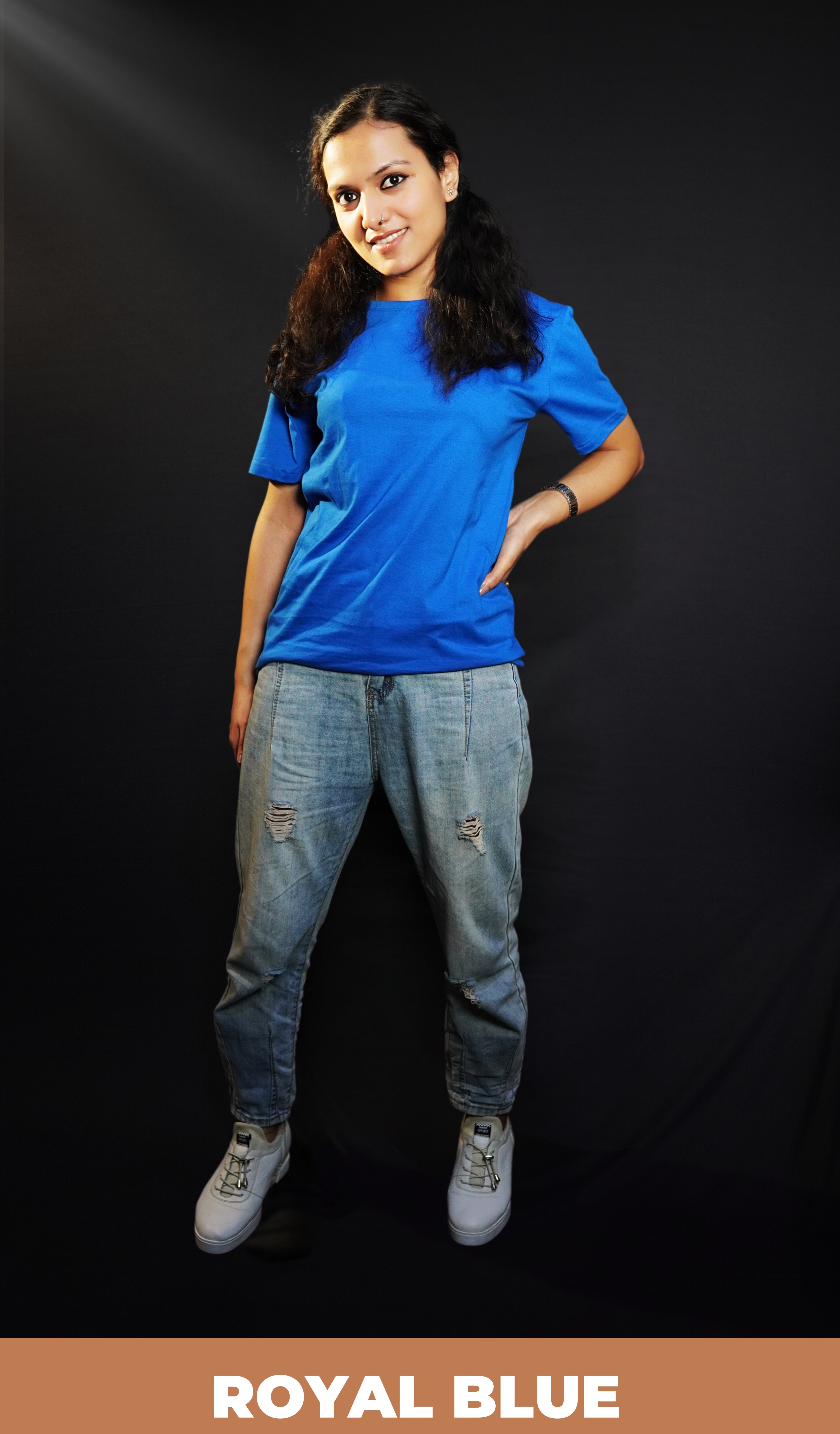 A woman wearing a cotton short sleeved round neck long t-shirt, posing with her hand on her waist and another hanging behind her, highlighting a modish slouchy fit-Muselot