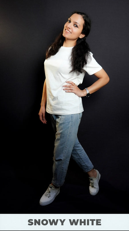 A model wearing a moisture wicking cotton round neck snowy white girl's t-shirt, posing with her hand on her waist and another hanging on her side as she stands sideways, highlighting a casual everyday look-Muselot