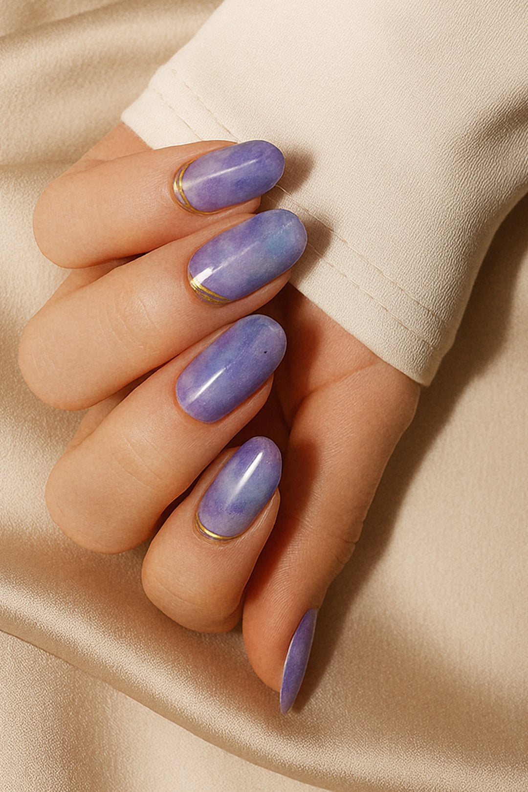 A model hand wearing Wavy Dream Lavender Marble Nail Art Stickies, showcasing a soft lavender marble design with subtle cloudy textures and elegant golden wave accents, adding a dreamy and artistic touch to the manicure-Muselot