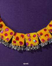 The Zard Bahaar yellow floral jewelry set, featuring hand-painted square tiles with pink-red floral motifs and silver ghungroo accents, laid flat for display – Muselot.