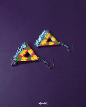 Zarmin triangle floral earrings rest against a rich purple background, highlighting the vivid yellow and pink hand-painted floral motifs and showcasing the playful silver jhumki drops that add movement and charm to the bold triangular silhouette — Muselot.