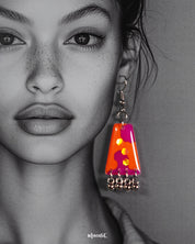 Model wearing the abstract Laalsavera earrings, with bold strokes of red and orange highlighted against her skin, enhancing the artistic appeal of the design while adding a touch of regal drama – Muselot