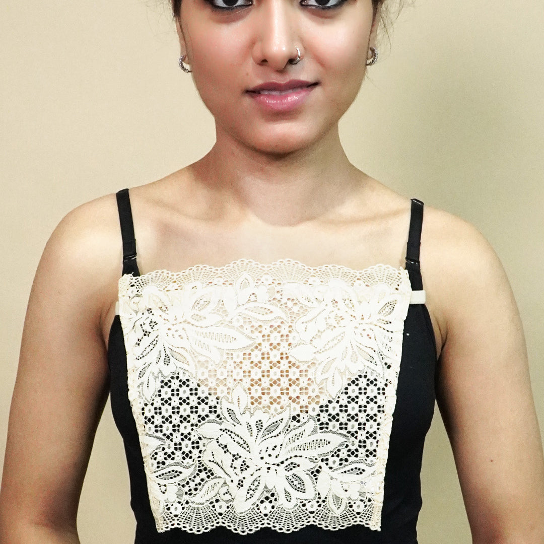 front view of woman holding beige lace camisole insert to show width and shape on beige background, showcasing lace mock camisole coverage for deep neckline tops – muselot