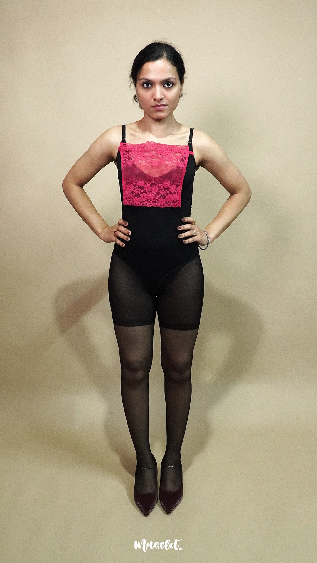 full body view of woman wearing dark pink lace camisole insert over black outfit on beige background, highlighting deep neck coverage styling with lace mock camisole for modest layering – muselot