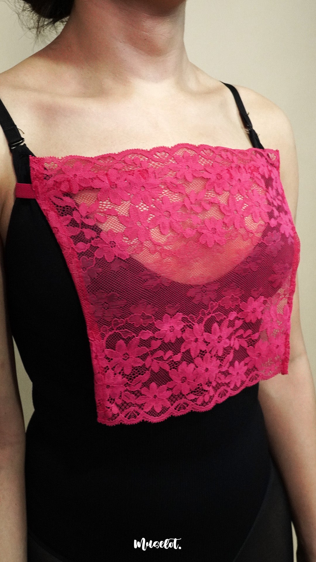 side angle close up of woman wearing dark pink lace camisole insert over black top on beige background, highlighting floral lace design and wide coverage for low neckline outfits – muselot