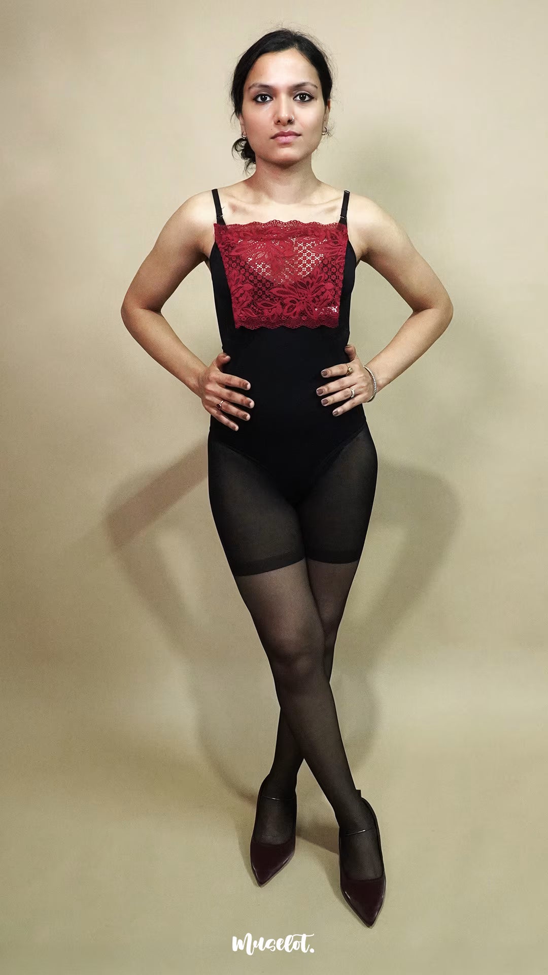 full body view of woman wearing maroon lace camisole insert over black outfit on beige background, highlighting deep neck coverage styling with lace mock camisole for modest layering – muselot