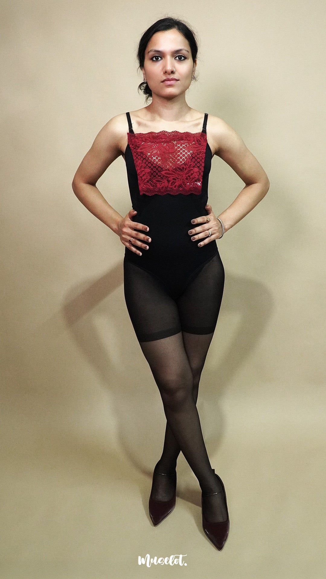 full body view of woman wearing maroon lace camisole insert over black outfit on beige background, highlighting deep neck coverage styling with lace mock camisole for modest layering – muselot