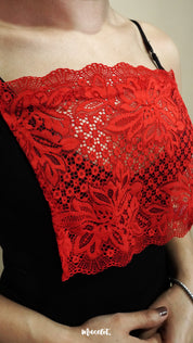 side close up of woman wearing red lace camisole insert over black top on beige background, highlighting wide lace design for better coverage on low neckline outfits – muselot