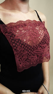 close up of woman wearing muselot burgundy lace camisole insert over black top on beige background, highlighting floral lace neckline coverage for deep neck dresses and cleavage cover styling-Muselot