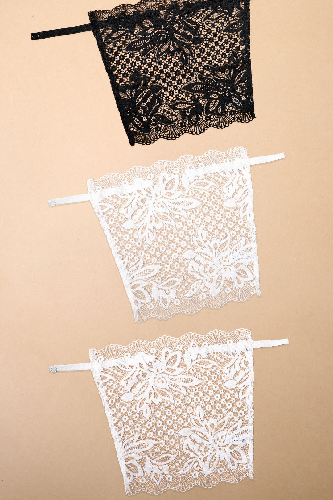 A pack of three clip-on neckline covers in black and white is displayed on a beige background. Featuring premium floral lace, adjustable straps and elegant scalloped edges, these deep neck cover-ups blend effortlessly with dresses, tops, kurtis and blouses, adding stylish neckline coverage, layering versatility and a refined feminine touch without the bulk of a camisole – Muselot