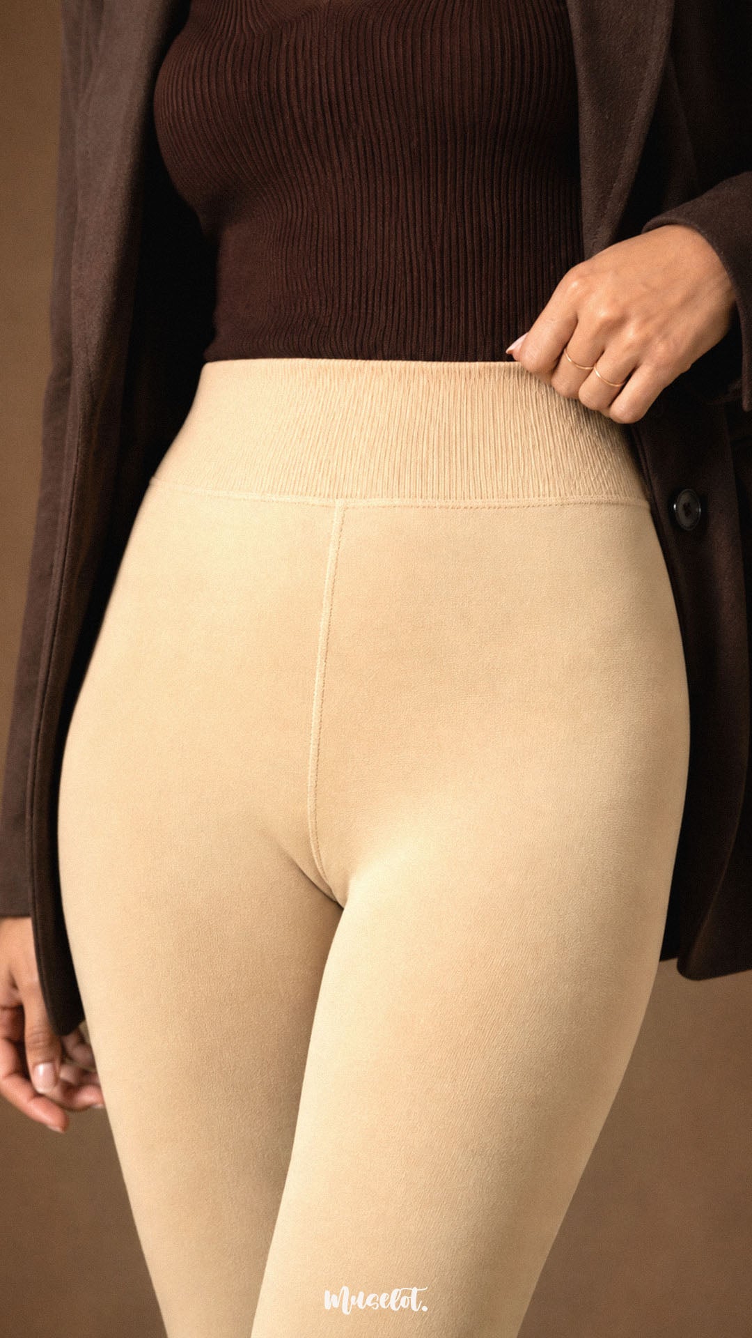 Close-up of beige fur lined winter stockings for women showing the wide ribbed high waistband, smooth opaque thermal fabric and fitted stretch finish - Muselot