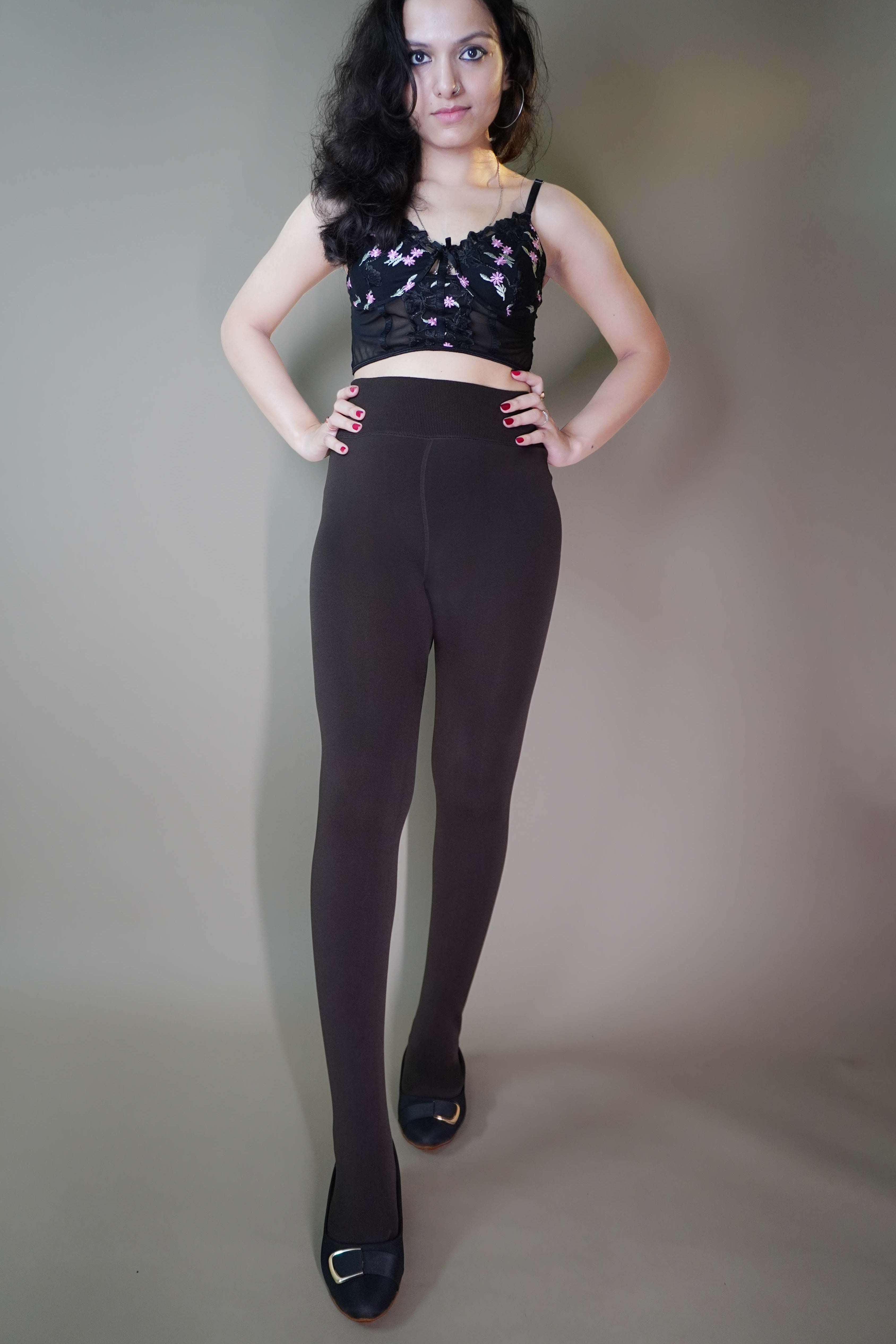 A model, wearing fur-lined cuddly latte warm tights, showcasing their soft, plush texture for added warmth. The latte color provides a cozy, stylish look perfect for colder weather. -Muselot
