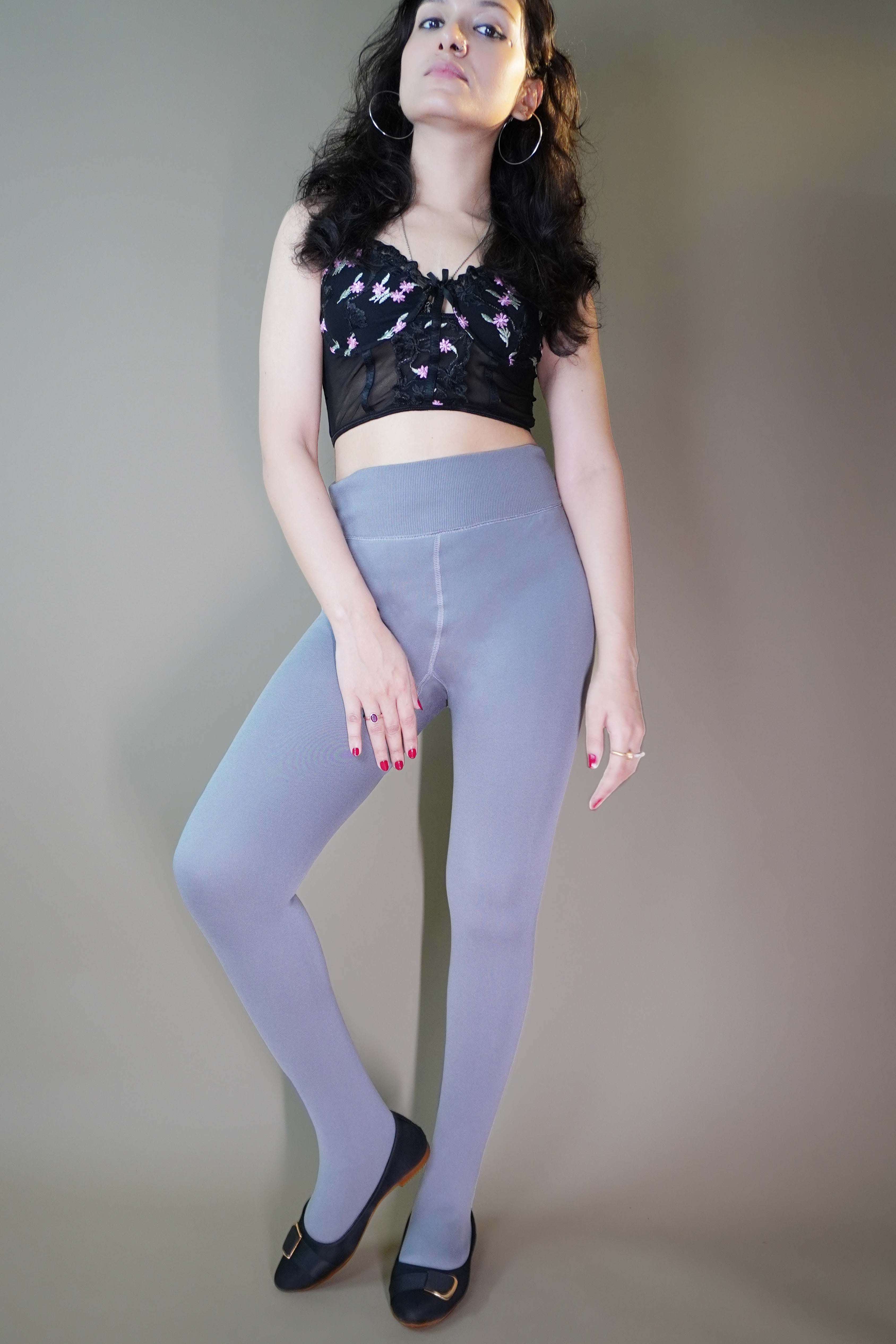 A model, wearing fur-lined grey warm stockings, showcasing their soft, insulating fabric that provides extra warmth and comfort. The grey color highlights a sleek, cozy design, making these stockings both stylish and practical for colder weather. -Muselot