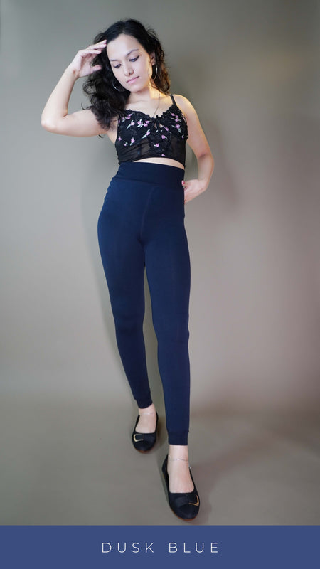 A stylish model wearing furry bliss dusk blue tights with a trendy top, showcasing the snug fit for stylish winter warmth. -Muselot
