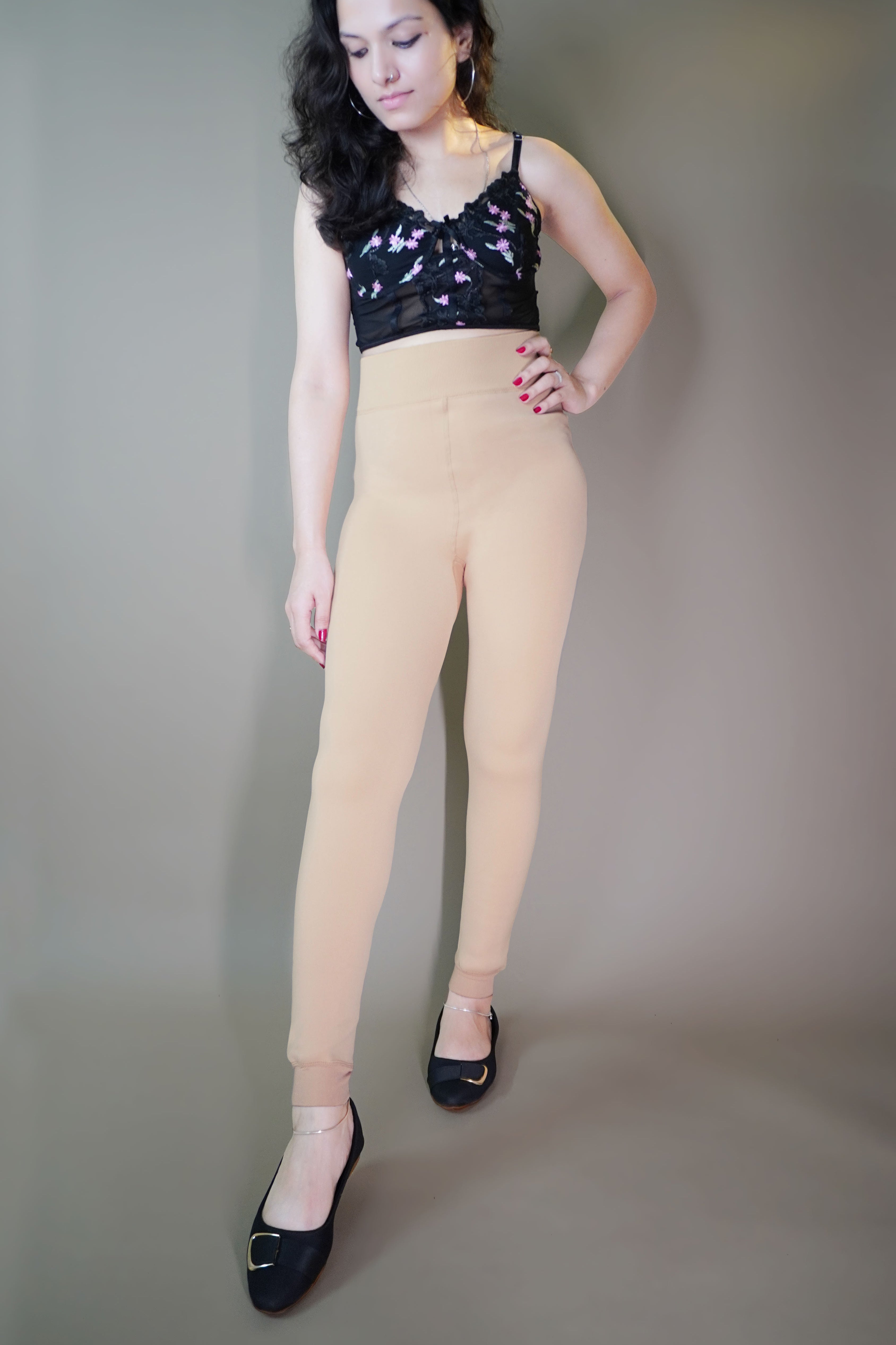 A stylish model, wearing furry skin-colored warm tights, highlighting their soft, fluffy texture that provides both warmth and comfort. -Muselot