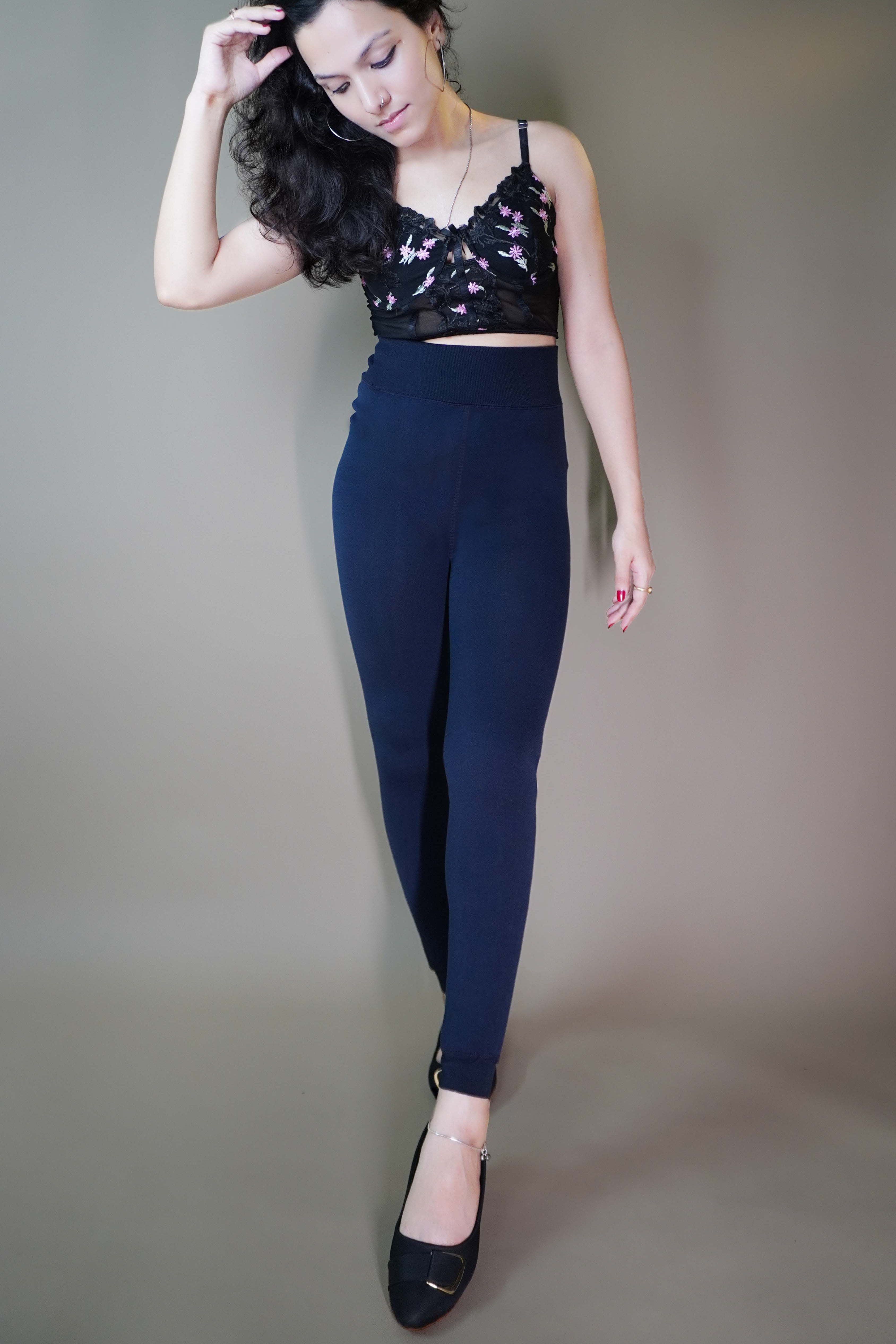 A beautiful model elegantly flaunting dark blue furry tights, highlighting their luxurious texture and unmatched warmth-Muselot