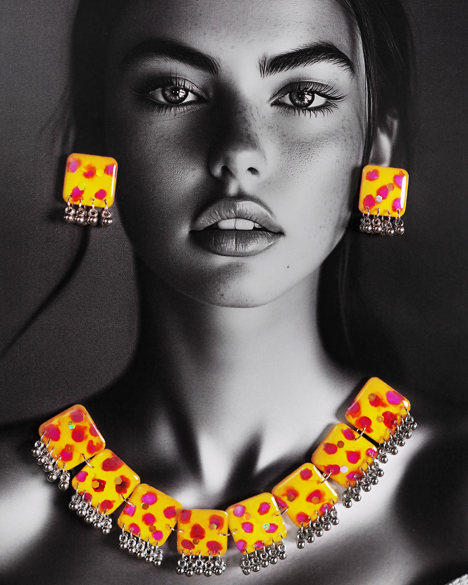 Model wearing hand-painted jewelry set, showcasing yellow square tiles with pink-red floral accents and silver ghungroo trimming for a vibrant traditional look – Muselot.