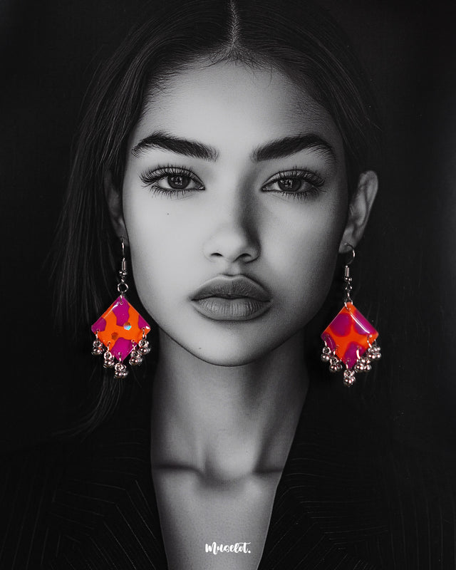 Model wearing the Laalsavera hook earrings, set against a rich dark backdrop, highlighting their sculptural abstract design and the bold charm they bring to any look – Muselot