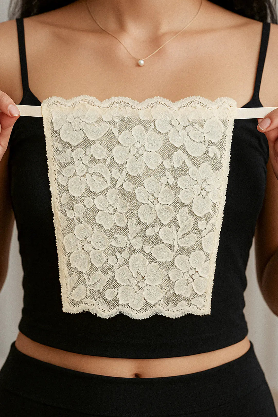 Close-up of model holding Lacy Beige Mockers, capturing the fine lacework and highlighting its graceful design for effortlessly styling deep-neck outfits – Muselot.