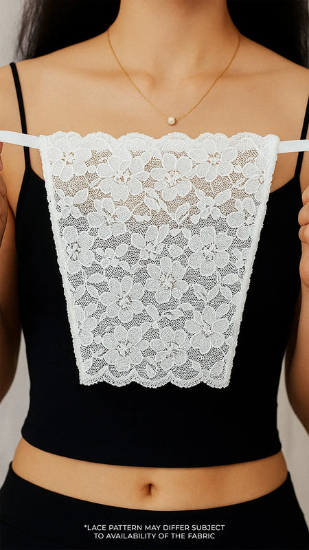 Close-up of model holding Lacy White Mockers, highlighting the delicate lace detail and timeless design that adds elegance to deep-neck outfits – Muselot.