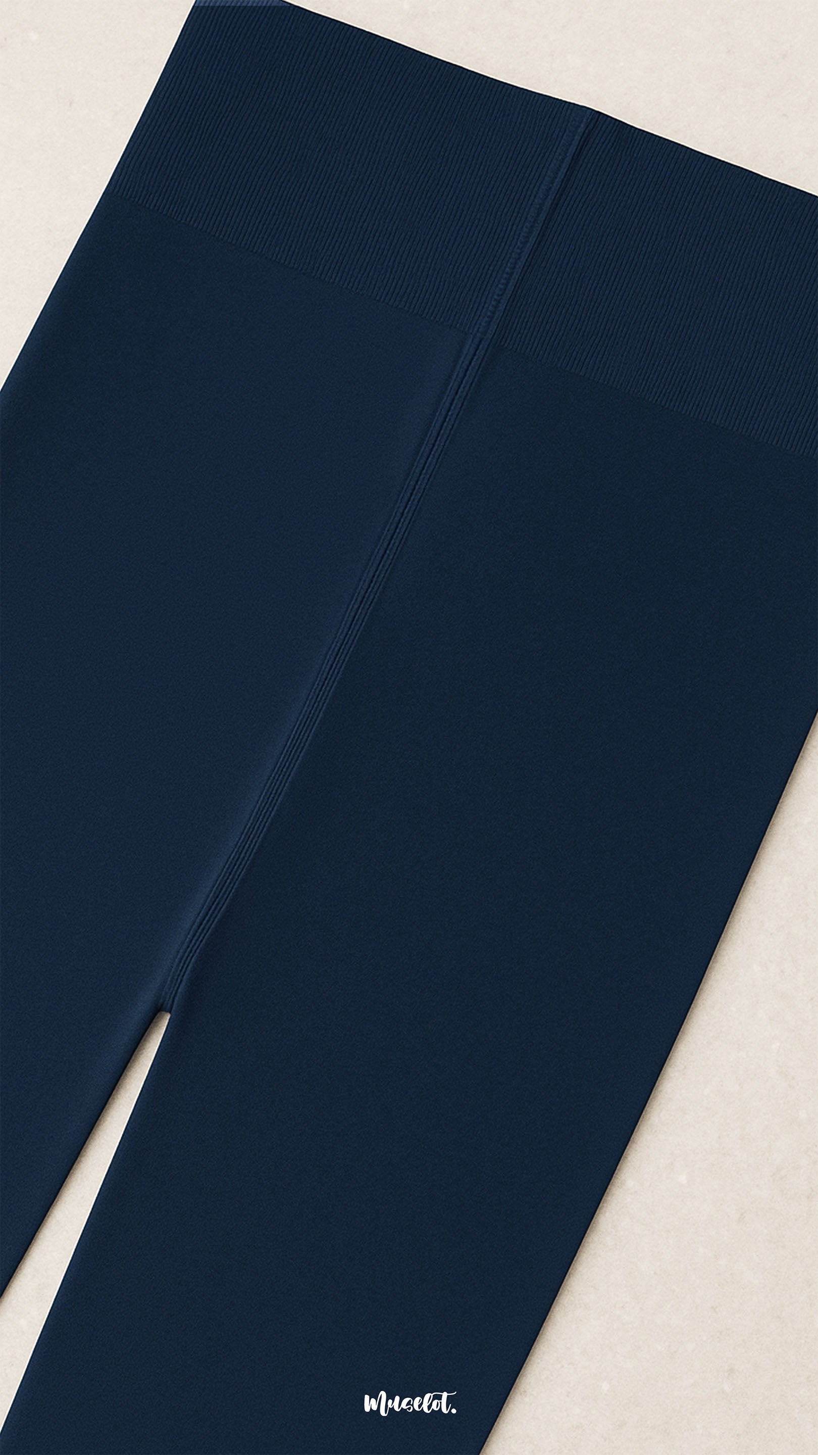 A close-up of navy blue semi-opaque tights showing the non-slip secure waistband with reinforced stitching for comfort, durability, and a snug fit - Muselot