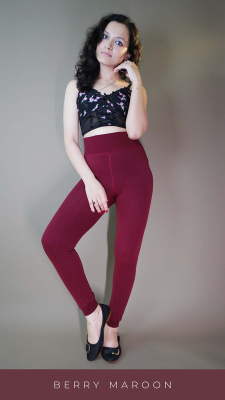 A model, wearing open-feet fur-lined maroon tights, highlighting the plush fur lining and open-foot design. The deep maroon color adds a bold touch, while the cozy texture provides warmth and comfort with a chic, modern twist. -Muselot