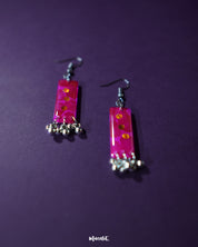 Close-up shot of red drop earrings adding a bold and elegant touch, showcasing their vibrant hue and sleek design – Muselot