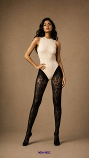 Full-length front view of a woman wearing black ornate designer lace stockings with semi-sheer patterning from waist to covered toes - Muselot