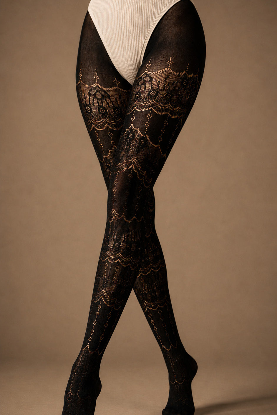 A zoom in view of crossed legs wearing Royal Black patterned stockings with intricate lace bands and delicate mesh detailing - Muselot