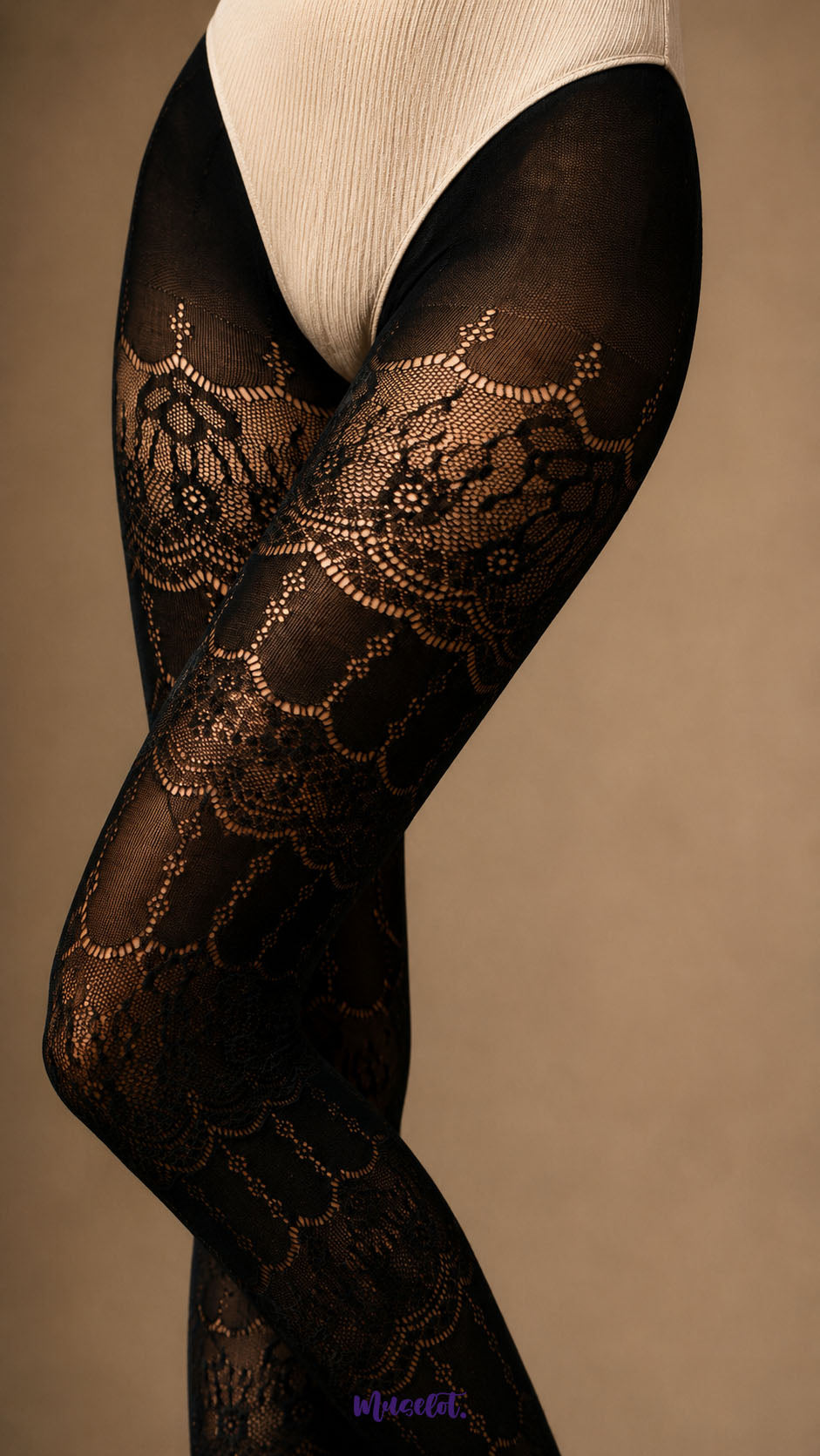 A detailed close-up of black ornate lace stockings across the thighs, showing layered scalloped motifs, fine mesh and decorative lace texture - Muselot