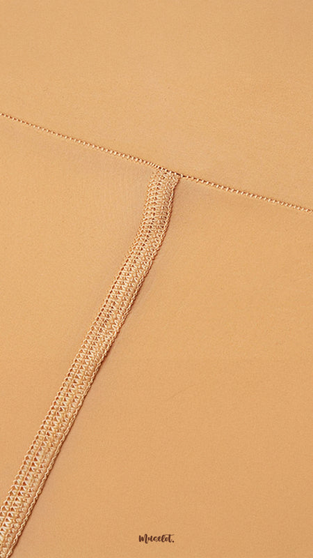 Close-up of secure waistband stitching on skin colored tights, highlighting strong seams, durability, and premium silken finish - Muselot