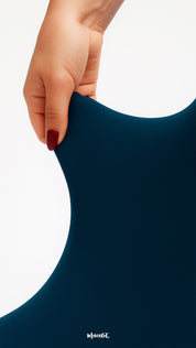 A close-up of a hand stretching navy blue semi-opaque tights, showcasing tear-proof strength, high elasticity, and smooth fabric quality - Muselot