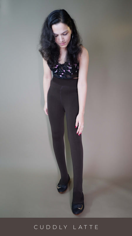 A model wearing stylish brown tights, showcasing their sleek, form-fitting design that adds a touch of elegance to any outfit. The rich brown hue highlights a versatile, chic look perfect for various occasions. -Muselot