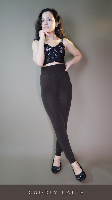 A model, wearing warm dark brown tights, showcasing their thick, cozy fabric that provides comfort and warmth. The dark brown shade highlighting a stylish, versatile look-Muselot